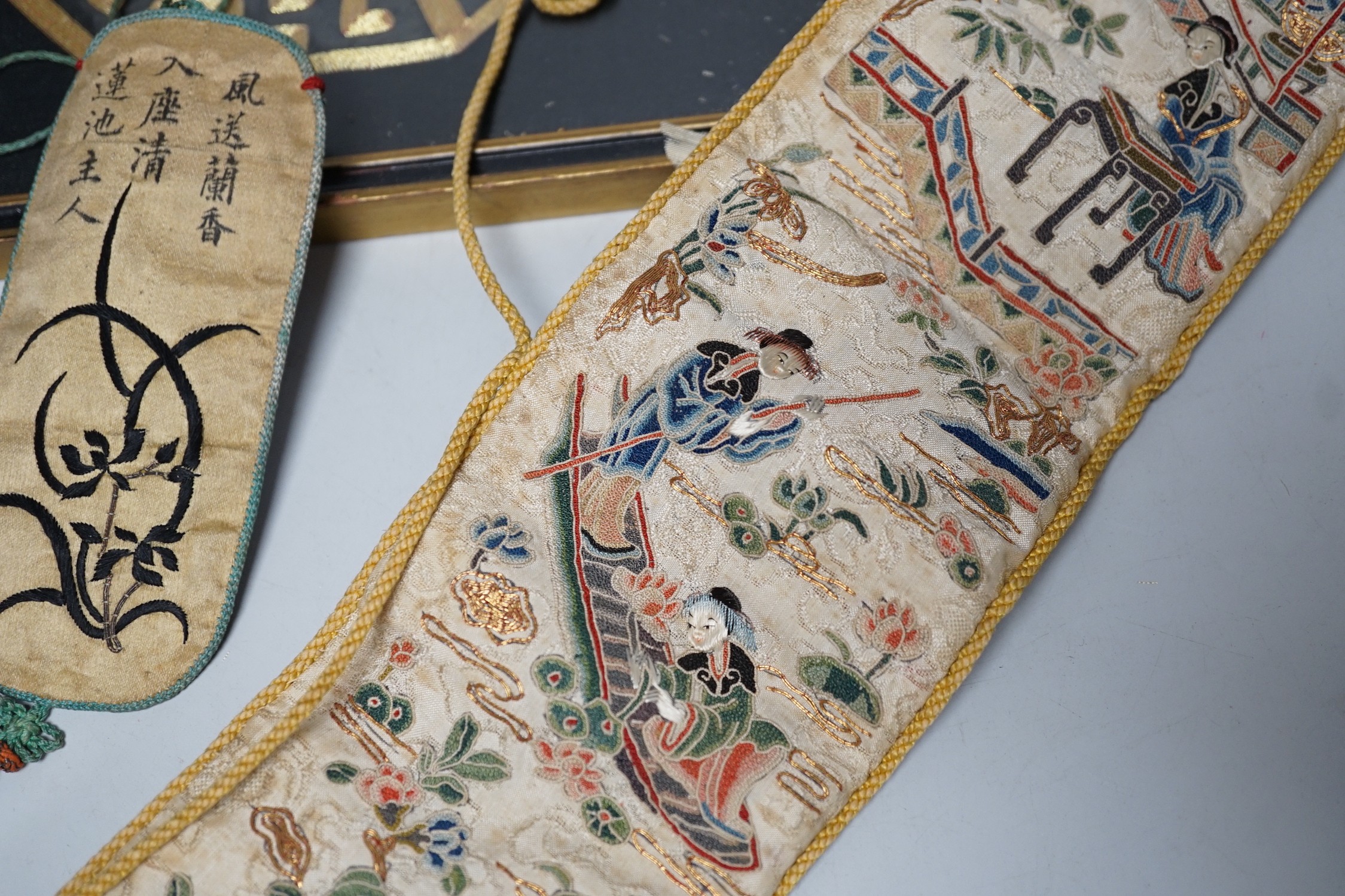 A pair of Chinese 19th century figurative sleeve bands, embroidered with polychrome and metallic threads, stitched in Peking knot and a Chinese embroidered silk purse, with a later panel, (3)